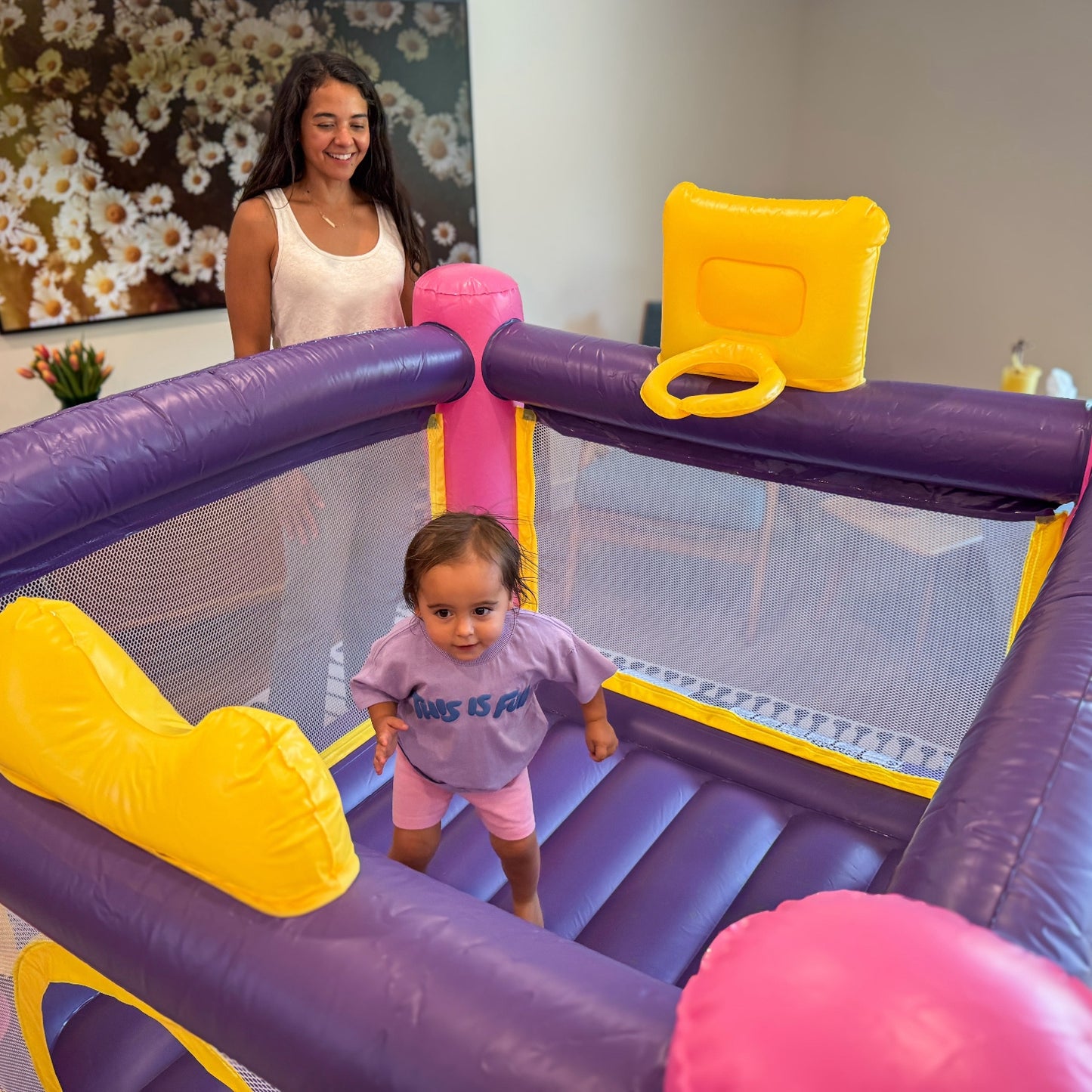 Child Playing in Disney Pricness Bounce House while parent supervises