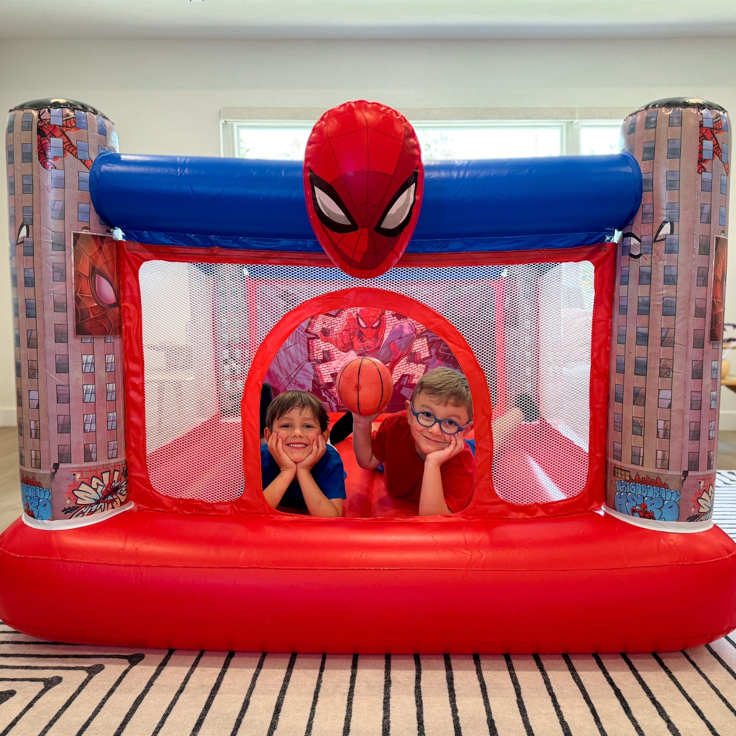 Children resting on the Soider-Man inflatable bounce house